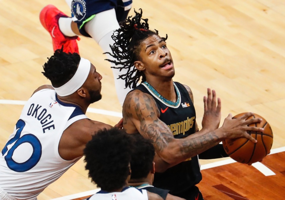 <strong>Grizzlies guard Ja Morant (right) drives the lane against Minnesota&rsquo;s Josh Okogie (left) on Friday, April 2, 2021, at FedExForum.</strong> (Mark Weber/The Daily Memphian)