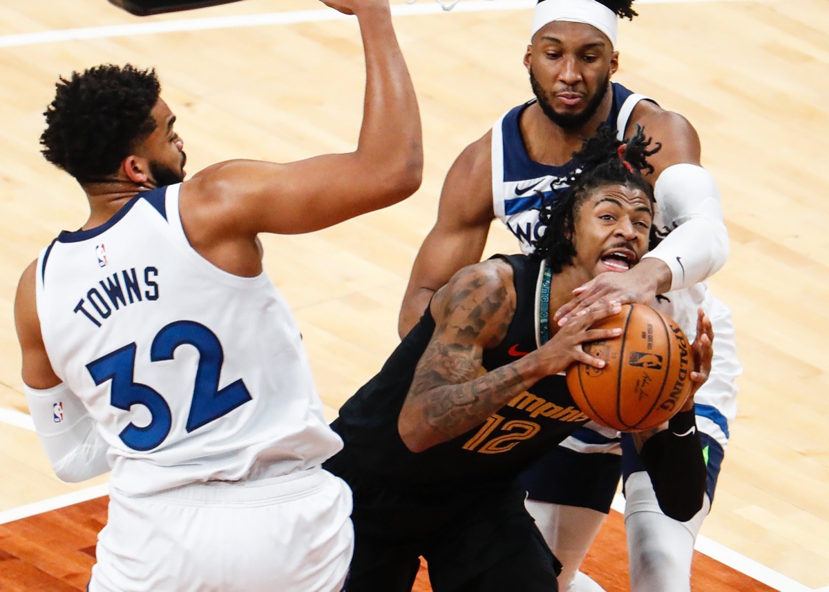 <strong>Grizzlies guard Ja Morant (middle) is fouled while driving to the basket against Minnesota&rsquo;s Karl-Anthony Towns (left) and Josh Okogie (right) on April 2.</strong> (Mark Weber/The Daily Memphian)