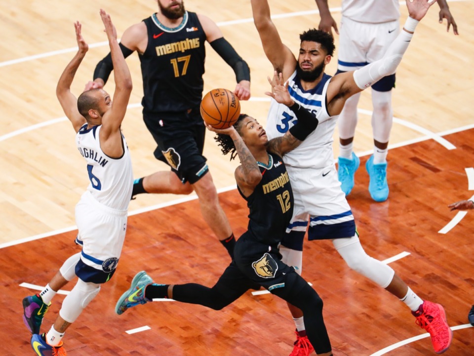<strong>Grizzlies guard Ja Morant (middle) drives against Minnesota&rsquo;s Karl-Anthony Towns (right) on Friday, April 2, 2021.</strong> (Mark Weber/The Daily Memphian)