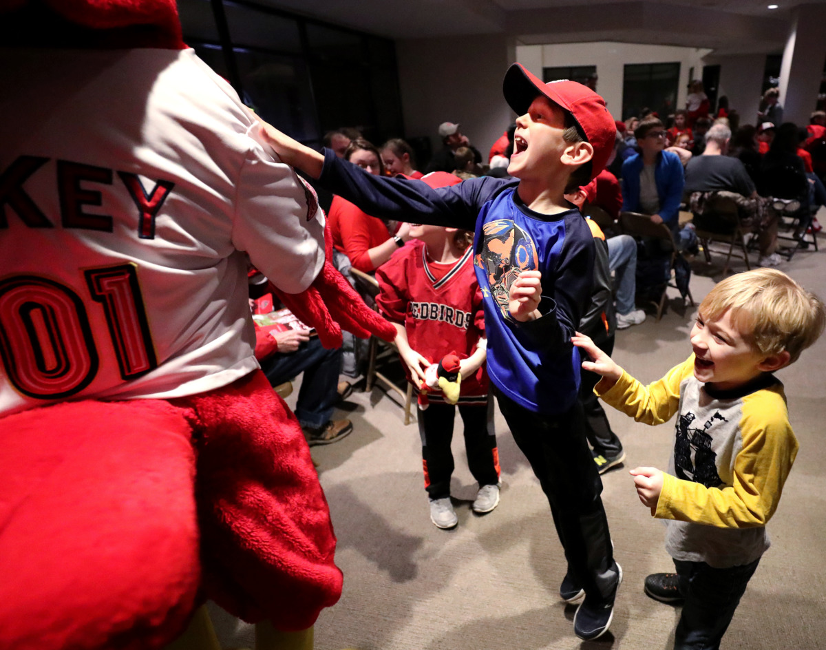 <strong>Whitman Steen (center), 8, and Carter Andrew McMinn (right), 6, charge gleefully toward Rockey the Redbird as the mascot greets fans at the Cardinals Caravan event Friday, Jan. 18, 2019. The annual event was held at AutoZone Park, where St. Louis Cardinals players and first base manager Stubby Clapp spoke with fans and signed autographs.</strong> (Houston Cofield/Daily Memphian)