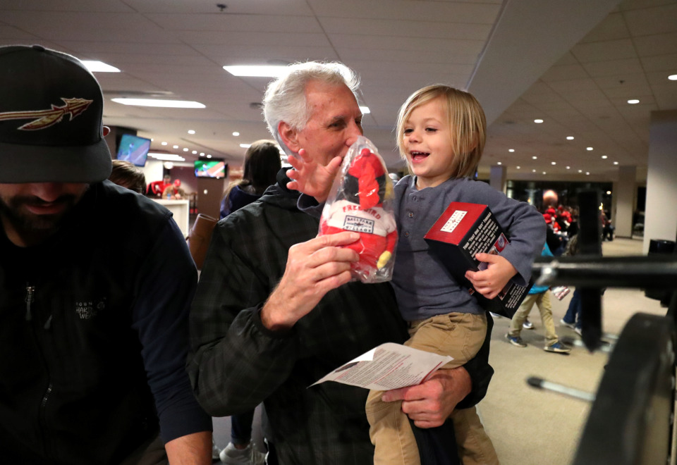 <strong>Lennox McMillon (right), 3, reaches for a door prize he won at the Cardinals Caravan event at AutoZone Park Friday, Jan. 18, 2019. Visitors filled the second floor of the stadium to hear their favorite players speak about what it takes to make it to the major leagues.</strong>&nbsp;(Houston Cofield/Daily Memphian)