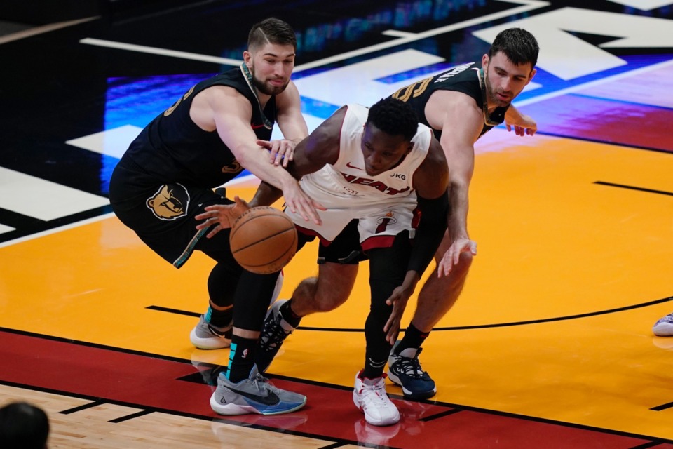 <strong>Miami Heat guard Victor Oladipo, middle, and Memphis Grizzlies center Killian Tillie, left, and guard John Konchar (46) go after the ball on April 6, 2021, in Miami.</strong> (Marta Lavandier/AP)