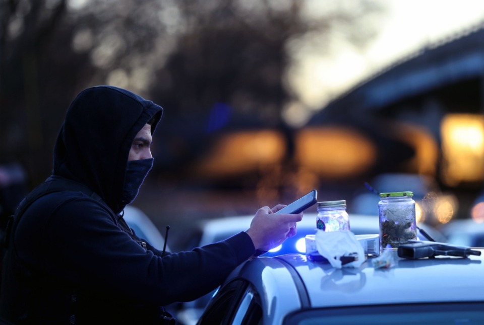 <strong>A Memphis Police officer photographs evidence found in a car while making an arrest on March 6.</strong> (Patrick Lantrip/Daily Memphian)