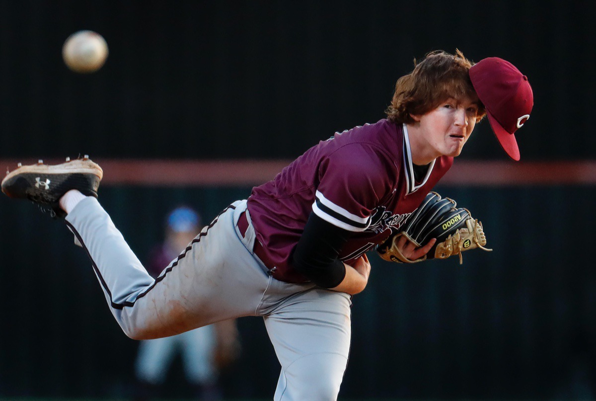 <strong>Collierville pitcher Bryce Griffith loses his cap while making a throw to home plate in the game against Houston on Thursday, April 8, 2021.</strong> (Mark Weber/The Daily Memphian)