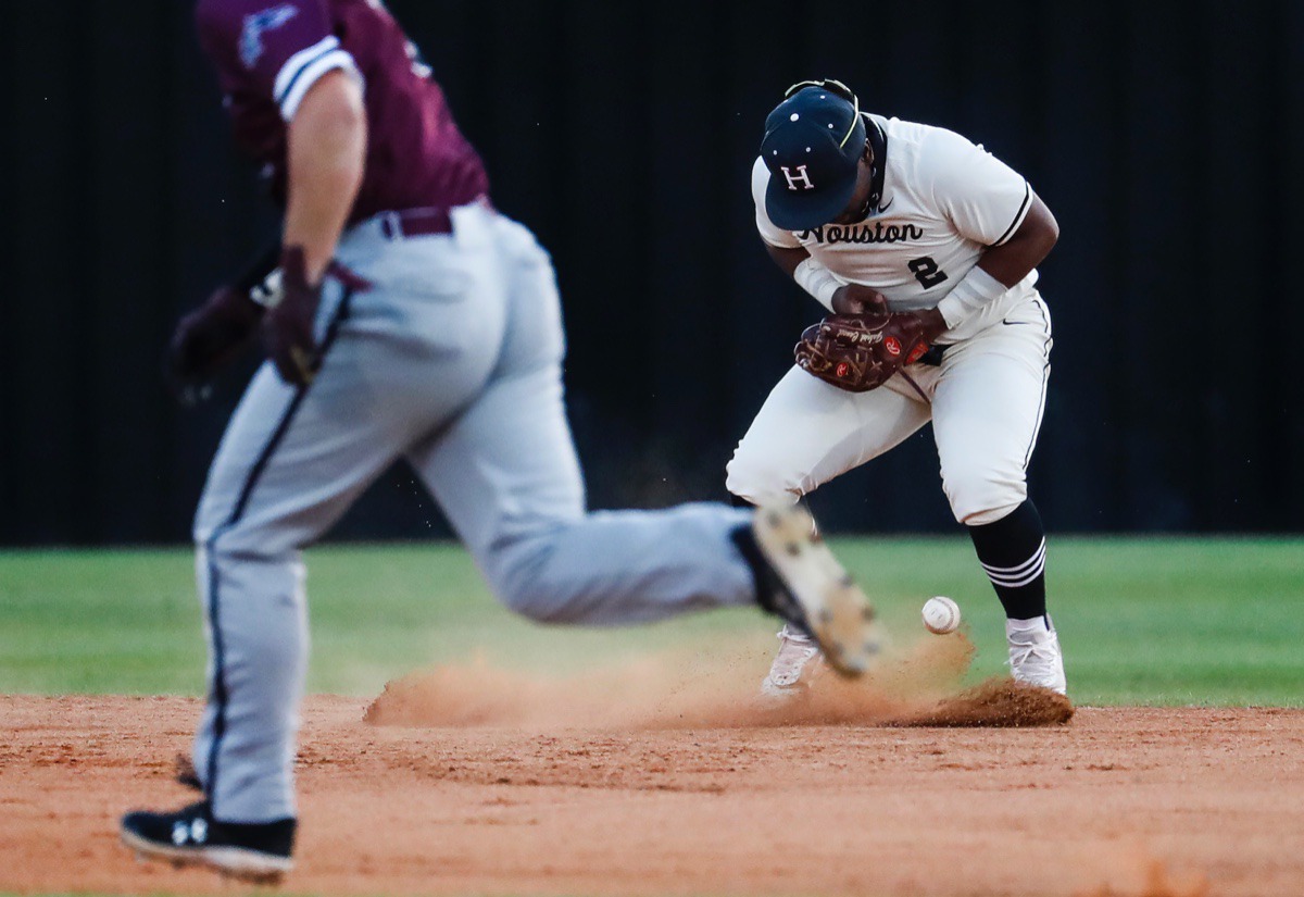 <strong>Houston second baseman Robinson Martin (right) drops a ground ball in the game against Collierville on April 8.</strong> (Mark Weber/The Daily Memphian)