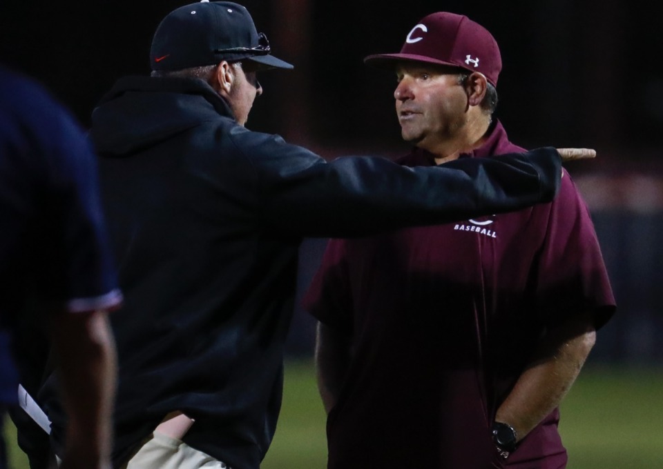 <strong>Collierville head coach Jeff Munier (right) and Houston head coach Lane McCarter (left) have a discussion on Thursday, April 8, 2021.</strong> (Mark Weber/The Daily Memphian)