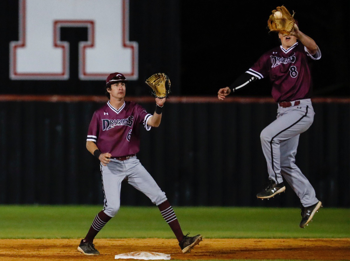 <strong>Collierville second baseman Seth Brown (right) cuts off a throw to shortstop Thomas Crabtree (left) to make a throw to home plate against Houston on April 8.</strong> (Mark Weber/The Daily Memphian)