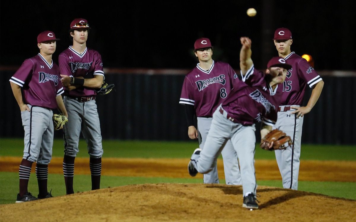 <strong>Collierville infielders watch as relief pitcher Ryan Neilson (front) warms up in the game against Houston on April 8.</strong> (Mark Weber/The Daily Memphian)