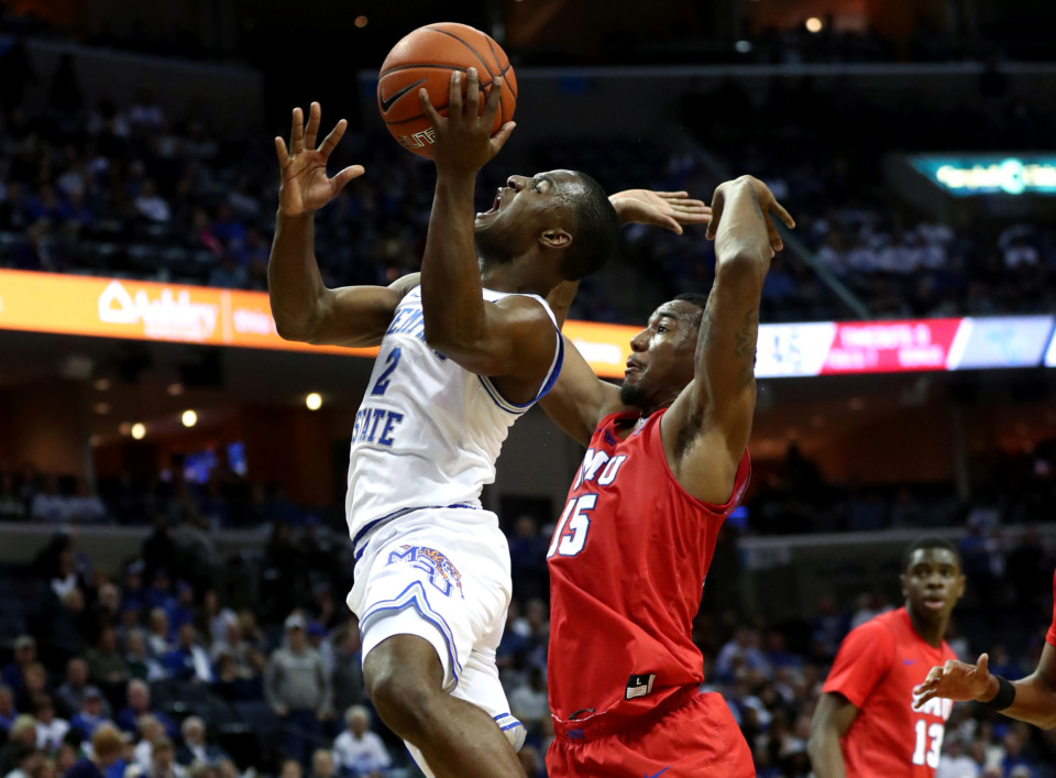 <strong>University of Memphis guard Alex Lomax (2) lunges for a lay-up against Southern Methodist University forward Isiaha Mike (15). The Tigers played an outstanding game defeating the Mustangs 83-61.</strong> (Houston Cofield/Daily Memphian)