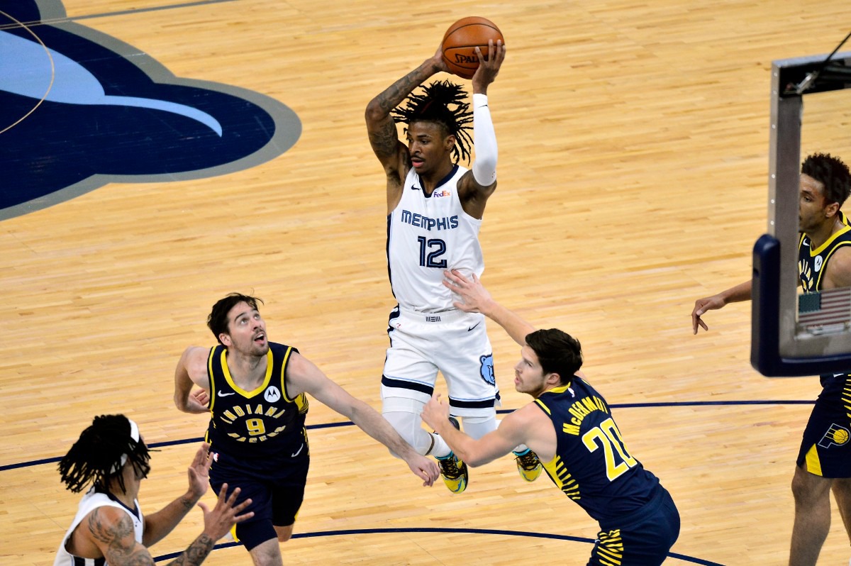 <strong>Memphis Grizzlies guard Ja Morant (12) handles the ball between Indiana Pacers guard T.J. McConnell (9) and forward Doug McDermott (20) in an NBA basketball game Sunday, April 11, 2021,at FedExForum.</strong> (Brandon Dill/AP)