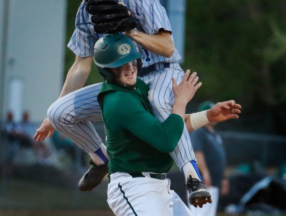 <strong>Briarcrest runner Tyler Harrington (left) is leveled by MUS starting pitcher Clarkson Shoaf (right) after scoring a run during action on Monday, April 12, 2021.</strong> (Mark Weber/The Daily Memphian)