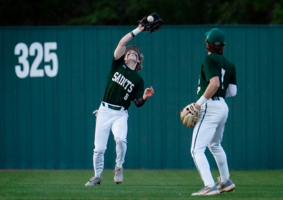 <strong>Briarcrest outfielder Eli Smith (left) snags a fly ball for an out against MUS on April 12.</strong> (Mark Weber/The Daily Memphian)