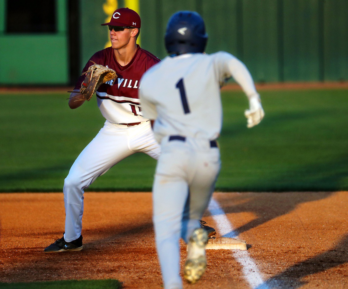 <strong>Collierville first baseman Grant Ross (15) receives the relay as Arlington centerfielder Josh Cooper (1) tries to beat the ball on April 13.</strong> (Patrick Lantrip/Daily Memphian)