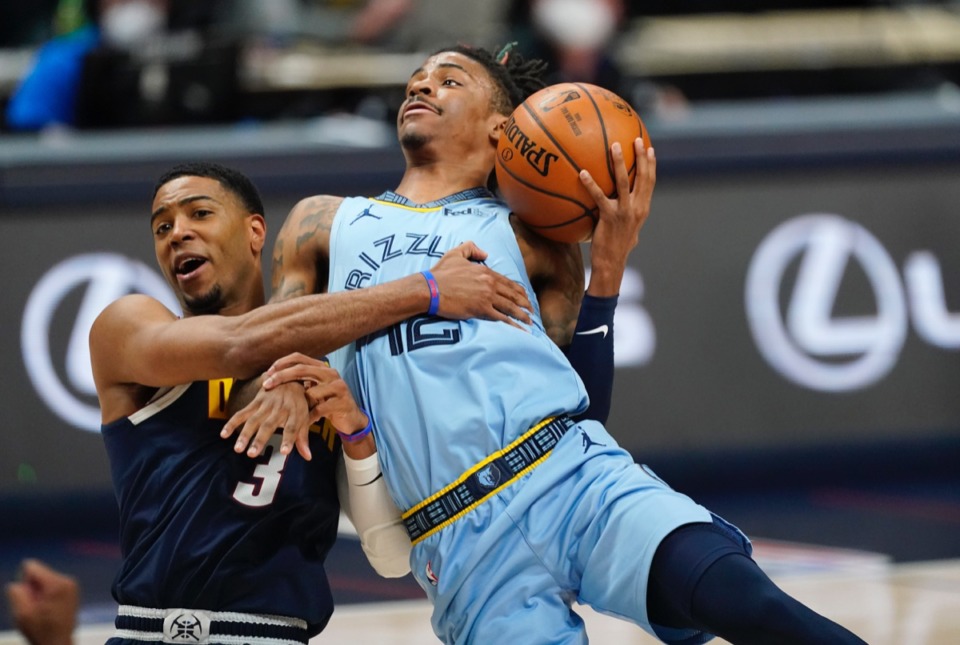 <strong>Grizzlies guard Ja Morant, right, is fouled by Denver Nuggets guard Shaquille Harrison on April 19 in Denver.</strong> (David Zalubowski/AP)