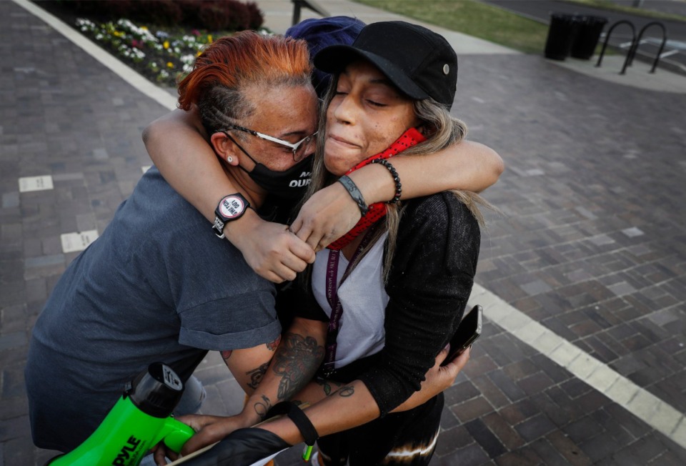 <strong>Local activists LJ Abraham (left) and Theryn Bond (back) embrace Bluu Davis (right) outside the National Civil Rights Museum, after a jury found former Minneapolis police officer Derek Chauvin guilty of murder and manslaughter Tuesday, April 20, in the death of George Floyd.</strong> (Mark Weber/The Daily Memphian)