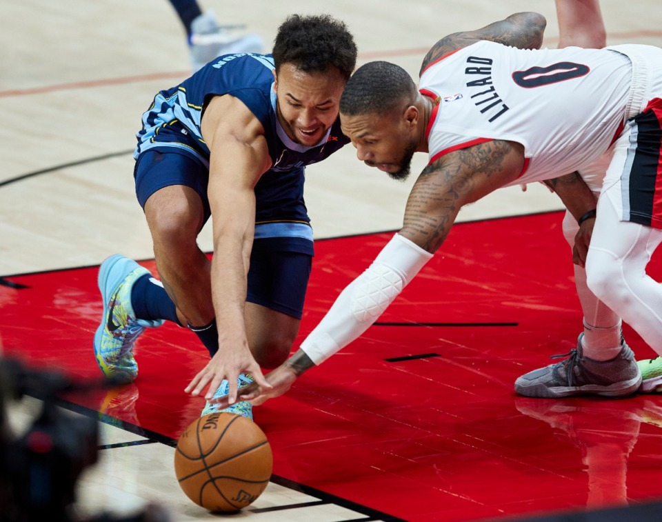 <strong>Memphis Grizzlies forward Kyle Anderson, left, and Portland Trail Blazers guard Damian Lillard reach for a loose ball during the second half of an NBA basketball game in Portland, Ore., Sunday, April 25, 2021.</strong> (Craig Mitchelldyer/AP)