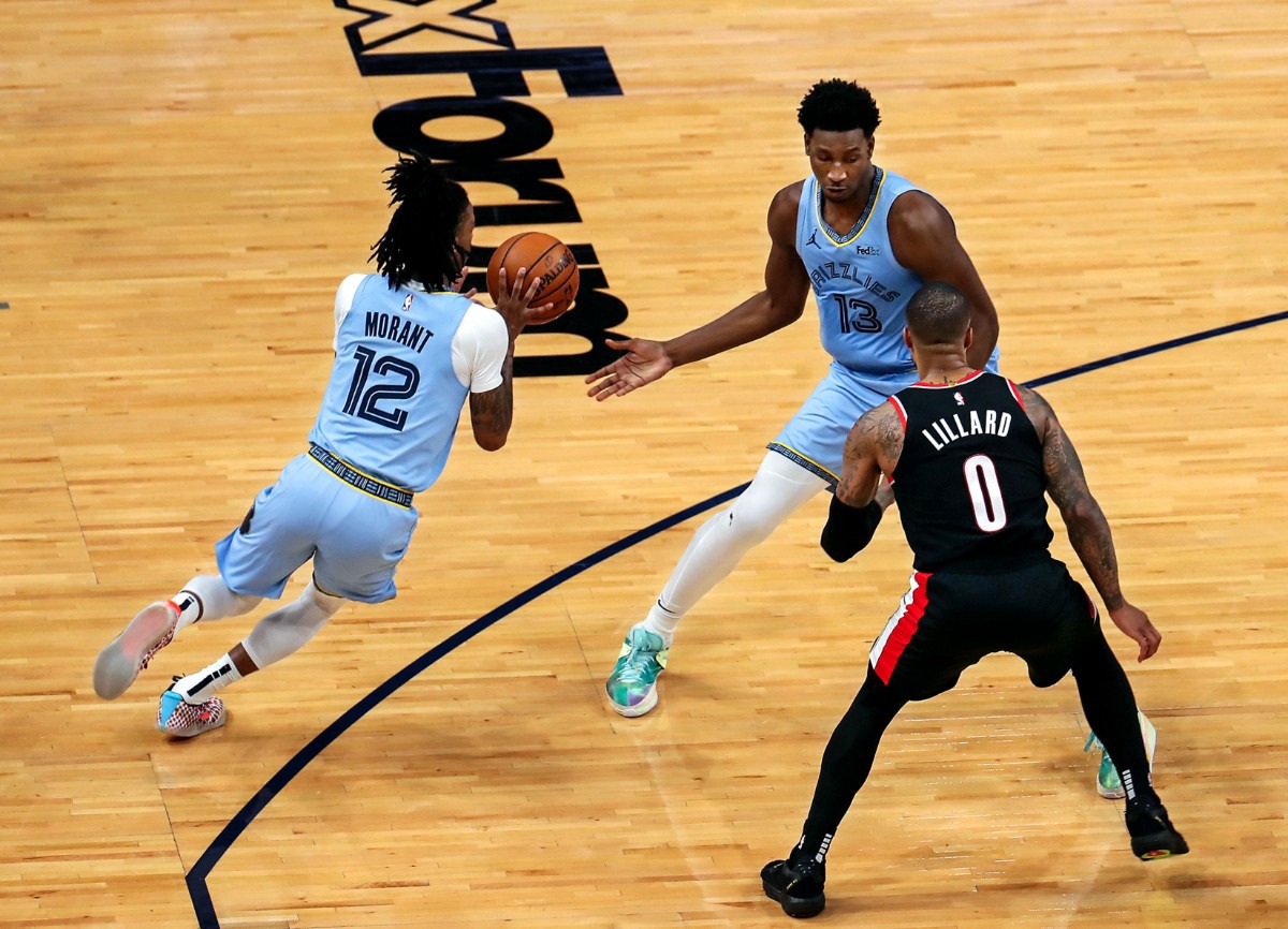 <strong>Grizzlies forward Jaren Jackson Jr. (13) hands the ball off to teammate Ja Morant (12) on April 28 at FedExForum in the game against Portland.</strong> (Patrick Lantrip/Daily Memphian)