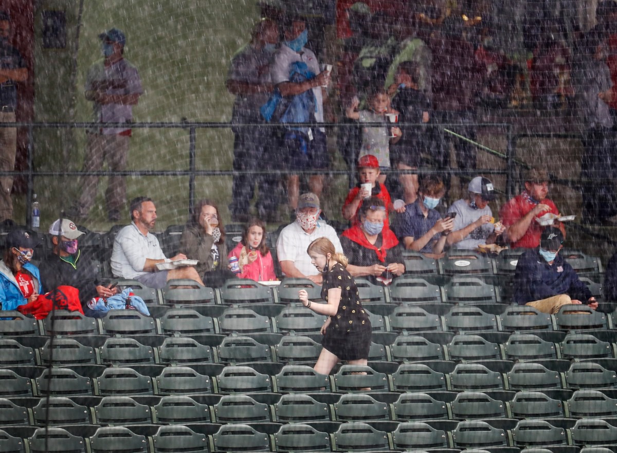 <strong>Fans run for cover during a rain delay before the Redbirds take on the Durham Bulls on Tuesday, May 4, 2021, at AutoZone Park.</strong> (Mark Weber/The Daily Memphian)