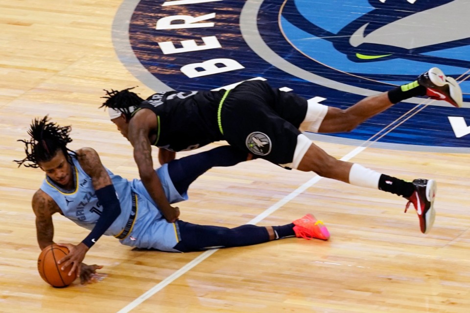 <strong>Memphis Grizzlies' Ja Morant hits the floor during a collision with Minnesota Timberwolves' Jarred Vanderbilt during the second half of an NBA basketball game Wednesday, May 5, 2021, in Minneapolis.</strong> (Jim Mone/AP)