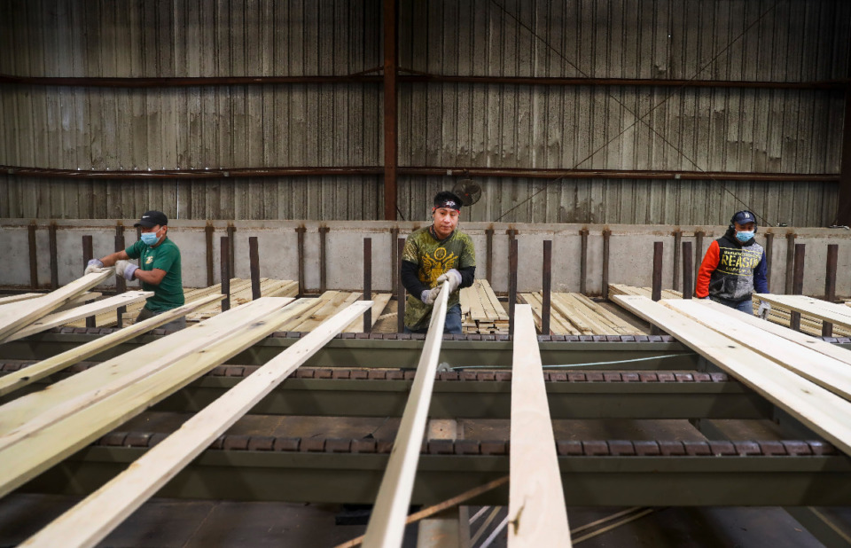 <strong>Workers sort lumber at Classic American Hardwood on April 2, 2021. Because of the pandemic and other factors the supply chains businesses use to get their products into market are behind schedule. New homebuyers might experience sticker shock over the high cost of lumber and other building materials.</strong> (Mark Weber/The Daily Memphian file)