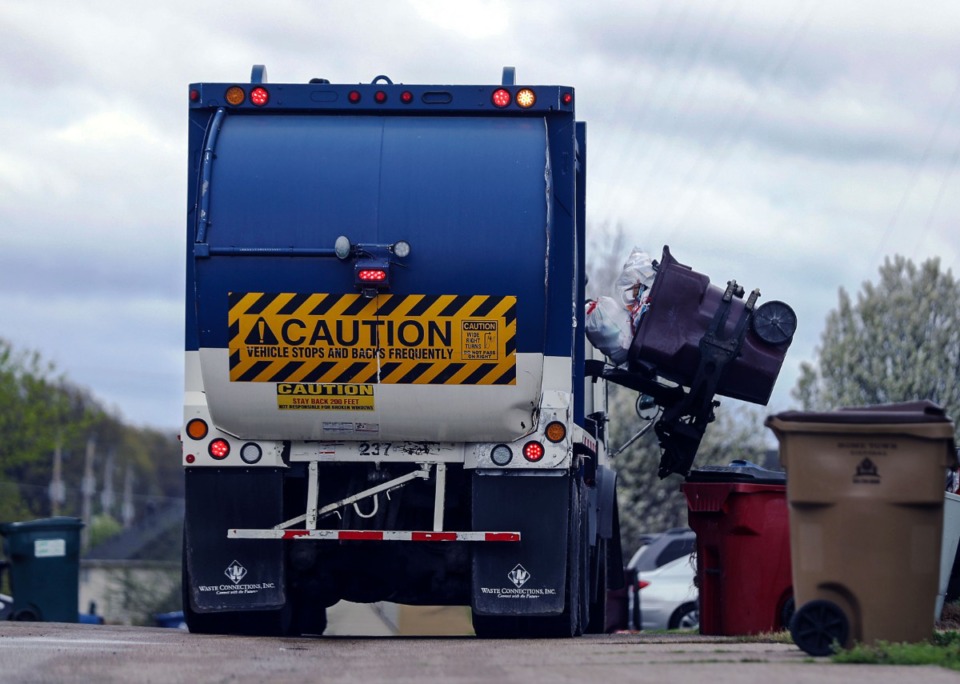 <strong>A garbage truck picks up an overflowing trash bin in Cordova on March 23.</strong> (Patrick Lantrip/Daily Memphian file)