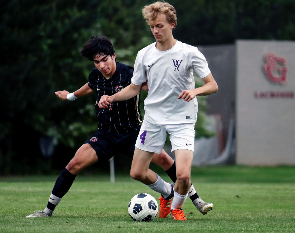 <strong>Westminster's Edmond Frakes (4) tries to keep the ball away from St. George's Luis Higareda (7) during a May 11, 2021 match.</strong> (Patrick Lantrip/Daily Memphian)