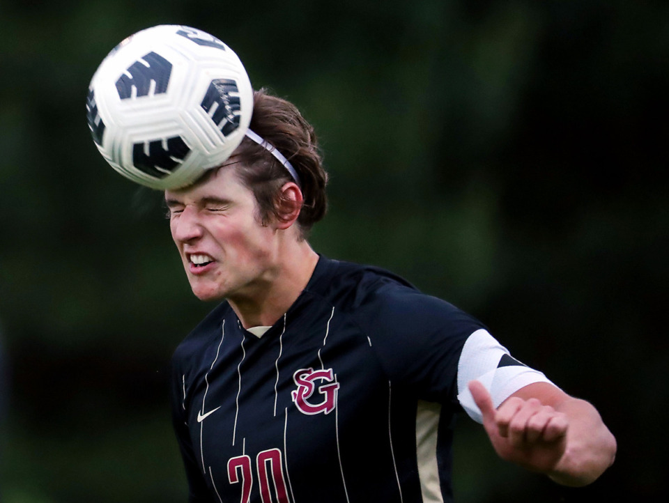 <strong>St. George's Ethan Payne (20) goes up for a header during a D-2A region soccer semifinal match May 11, 2021, against Westminster. The Gryphons won 3-1 and will play Lausanne in the title match.</strong> (Patrick Lantrip/Daily Memphian)