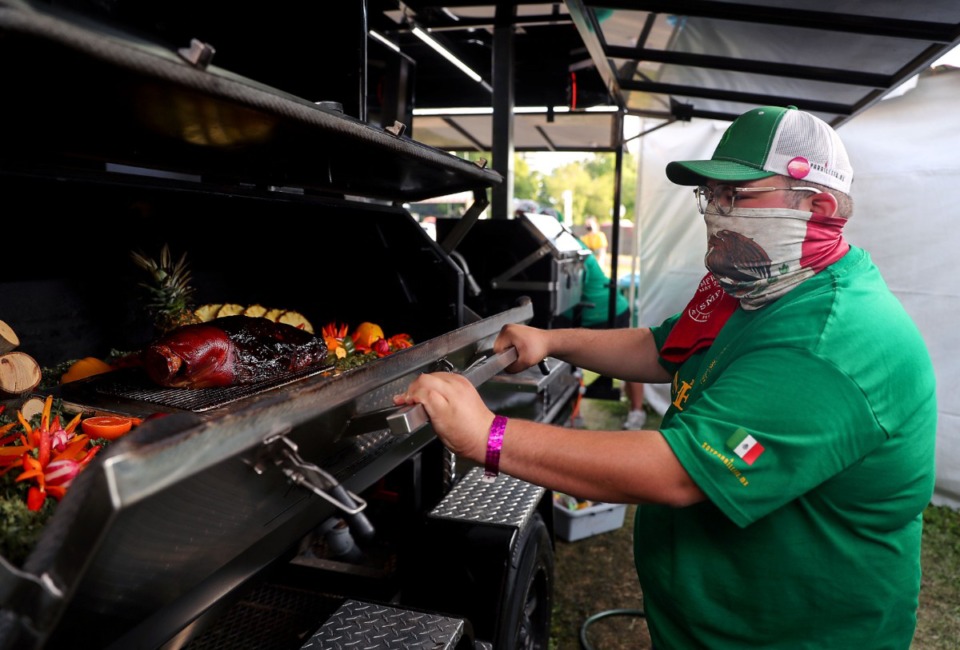 <strong>Sebastian De Alba checks on the pork shoulder at the Mexican BBQ Team tent, Saturday, May 15, 2021.</strong> (Patrick Lantrip/Daily Memphian)