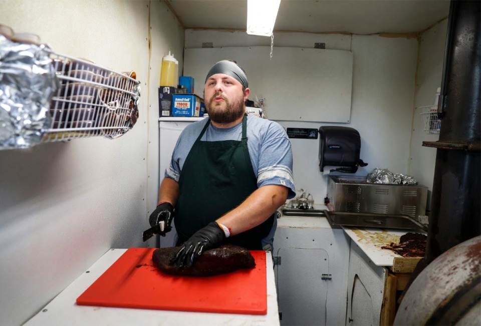 <strong>Bryant Bain, co-owner of Bain BBQ, slices brisket before opening his food truck on Sunday, May 16, 2021.</strong> (Mark Weber/The Daily Memphian)