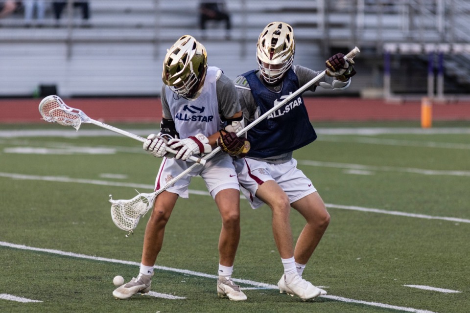 <strong>Mac Murphy, left, and Craig Allen, right, battle for the ball during the first annual lacrosse all-star game</strong> <strong>at CBHS May 18.</strong> (Brad Vest/Special to The Daily Memphian