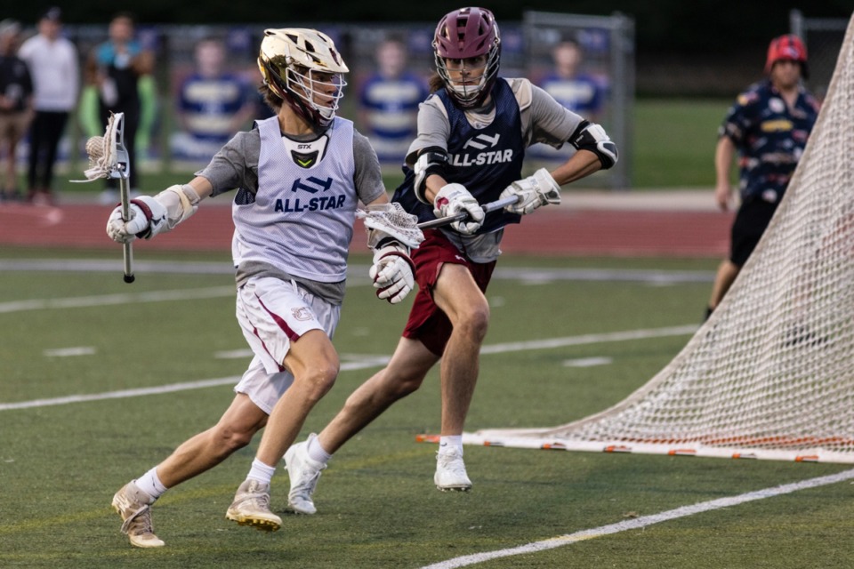 <strong>John Miraglia, left, looks to make a pass during the first annual lacrosse all-star game at CBHS May 18.</strong> (Brad Vest/Special to The Daily Memphian