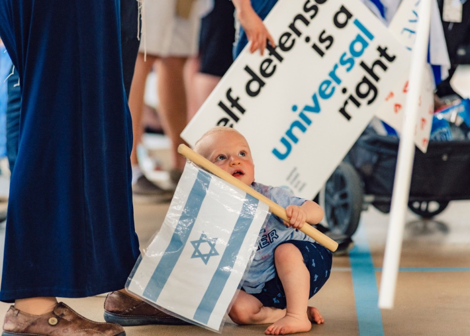 <strong>A baby crawls through the crowd gathered at the Jewish Community Center in support of Israel May 19.</strong>&nbsp;(Houston Cofield/Special to The Daily Memphian)
