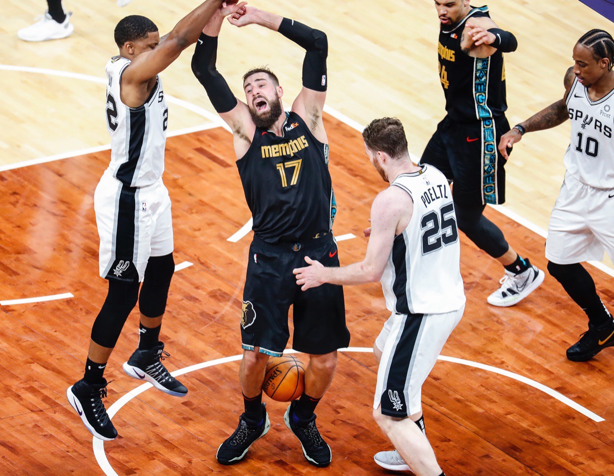 <strong>Grizzlies center Jonas Valanciunas traps the ball with his legs while San Antonio&rsquo;s Rudy Gay (left) and Jakob Poeltl (right) defend on May 19 at FedExForum.</strong> (Mark Weber/The Daily Memphian)