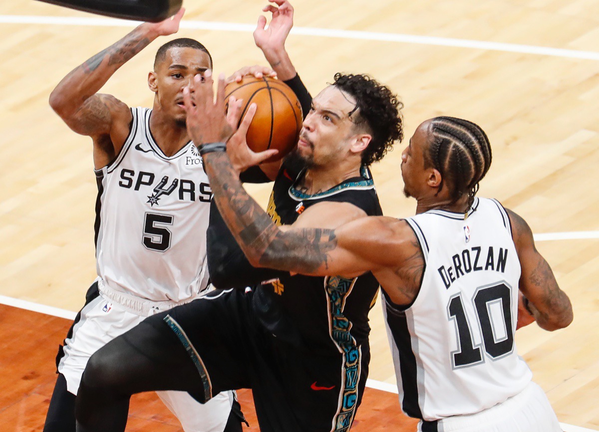 <strong>Grizzlies guard Dillon Brooks (middle) is fouled while driving the lane against San Antonio&rsquo;s Dejounte Murray (left) and DeMar DeRozan (right) on May 19, 2021, at FedExForum.</strong> (Mark Weber/The Daily Memphian)