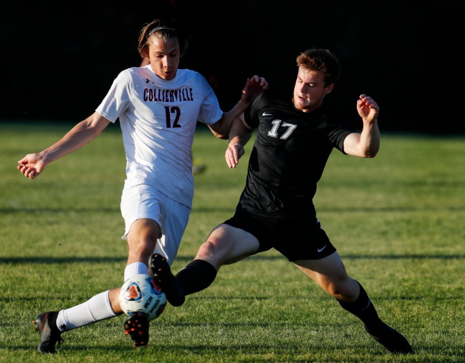 <strong>Collierville&rsquo;s Charlie Jones (left) battles Houston forward Zach Page (right) on Thursday, May 20, 2021.</strong> (Mark Weber/The Daily Memphian)