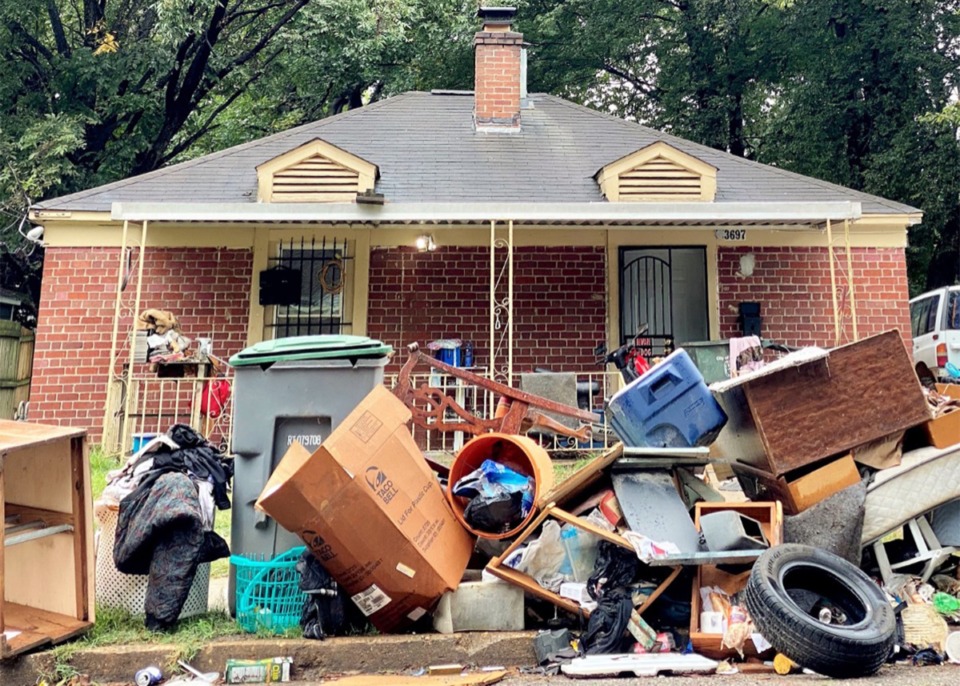 <strong>Personal belongings are piled outside a&nbsp;house on Townes Avenue, near National Cemetery.</strong> (Tom Bailey/Daily Memphian file)
