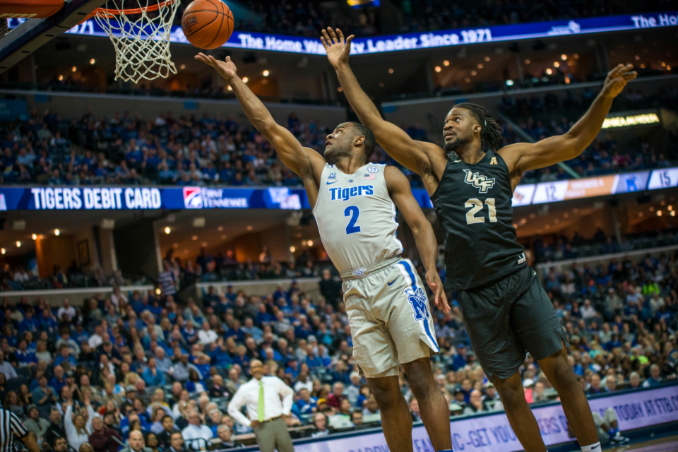 <strong>Memphis guard Alex Lomax goes to the basket with UCF's Chad Brown looking to defend during Sunday's 77-57 Tigers' victory over the Knights.</strong> (Matthew A. Smith/University of Memphis)