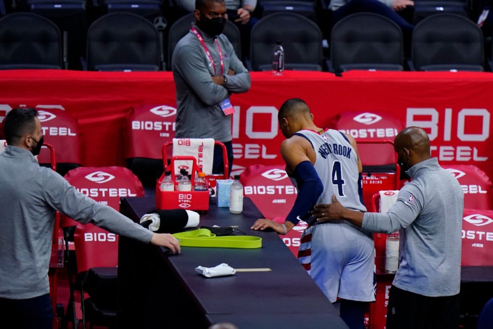 <strong>Washington Wizards' Russell Westbrook (4) is helped to the locker room after an injury May 26, 2021, in Philadelphia. As he was leaving, someone sitting over the tunnel that leads from the floor threw popcorn on him.</strong> (Matt Slocum/AP)