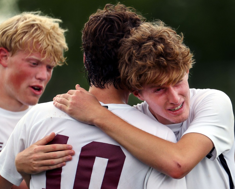 <strong>Bearden High School midfielder Dylan Kolnick (7), Julian Strickland (10) and Cameron Cook (11) console each other after a loss to Houston High School in the Class AAA championship game in Murfreesoro, Tennessee, on May 28, 2021.</strong> (Patrick Lantrip/Daily Memphian)