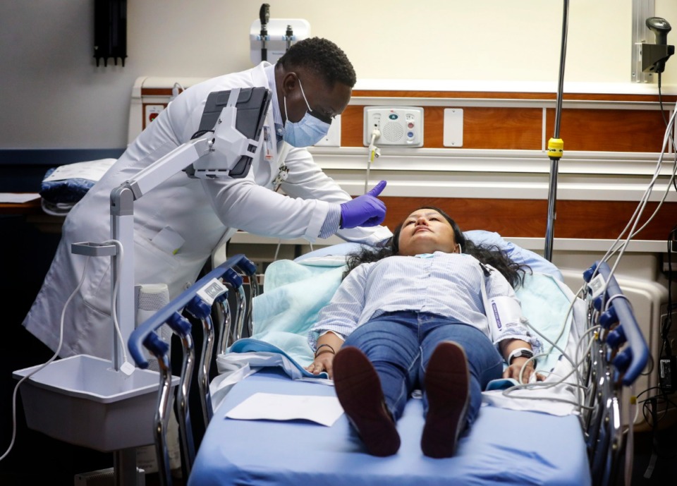 <strong>Dr. Amos Raymond, an emergency room physician at Memphis VA Medical Center, evaluates stroke patient (Joy Barrera) during a Telestroke simulated exercise on Thursday, May 27.</strong> (Mark Weber/Daily Memphian)