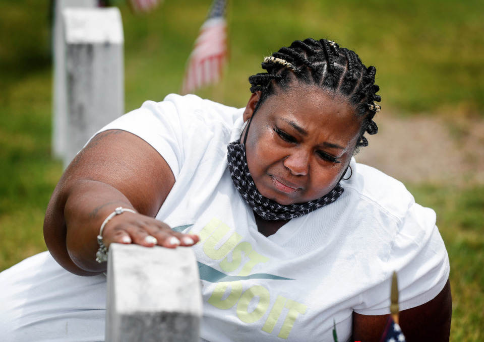<strong>Tiera Harris sheds tears while touching her grandfather&rsquo;s tombstone on Memorial Day at the West Tennessee Veterans Cemetery on Monday, May 31, 2021.</strong> (Mark Weber/The Daily Memphian)