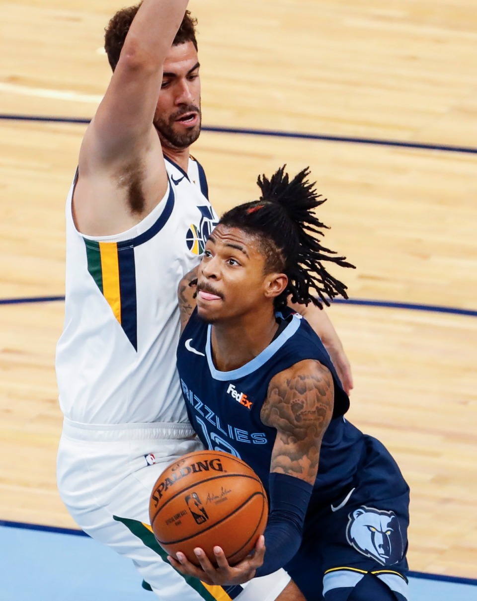 <strong>Memphis Grizzlies guard Ja Morant (right) drives the lane against Utah Jazz defender Georges Niang (left) during action of game four of the NBA playoffs on Monday, May 31, 2021.</strong> (Mark Weber/The Daily Memphian)