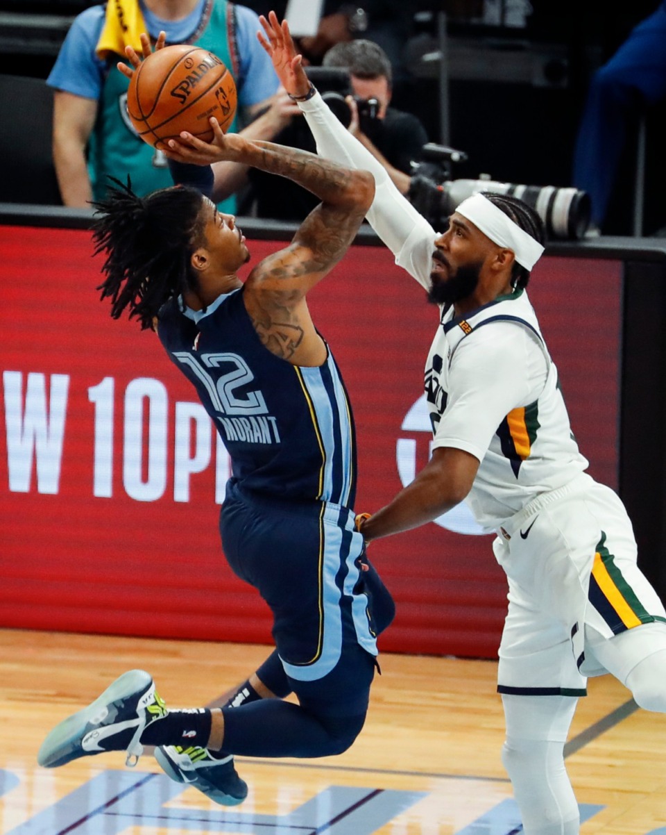 <strong>Memphis Grizzlies guard Ja Morant (left) drives the lane against Utah Jazz defender Mike Conley (right) during action of game four of the NBA Playoffs on Monday, May 31, 2021.</strong> (Mark Weber/The Daily Memphian)