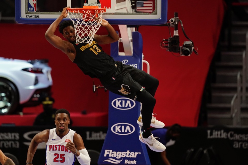 <strong>Grizzlies forward Jaren Jackson Jr. hangs on the rim after a dunk aon May 6.</strong> (Carlos Osorio/AP file)
