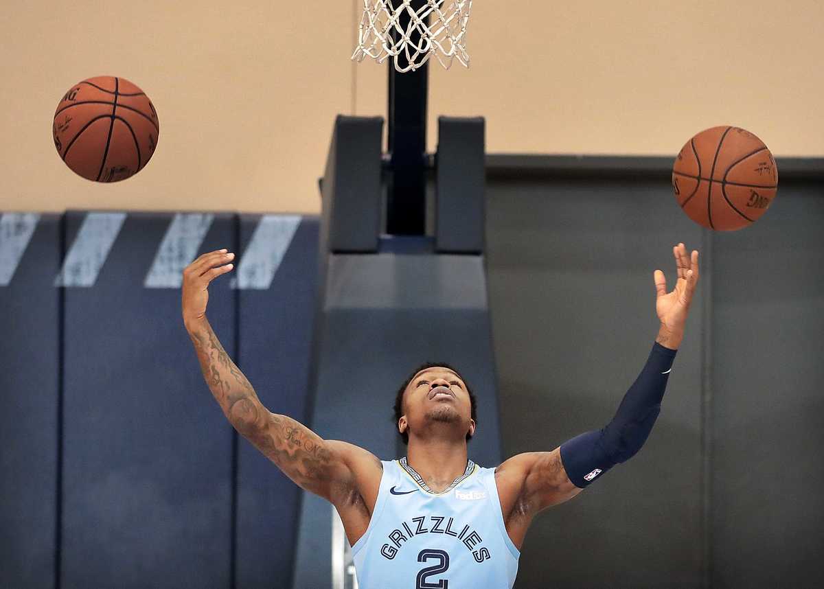 <strong>Grizzlies guard Brandon Goodwin tries to make a double-shot while waiting for photographers to shoot his portrait i the practice gym during the annual Grizzlies media day at the FedExForum on Sept. 24, 2018.</strong> (Jim Weber/Daily Memphian)