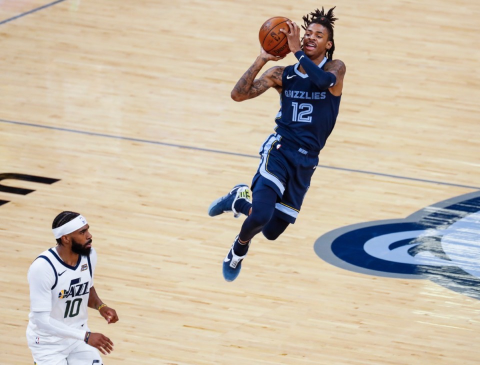 <strong>Memphis Grizzlies guard Ja Morant (right) puts up a shot after being fouled by Utah Jazz defender Mike Conley (left) during action of game four of the NBA Playoffs on Monday, May 31, 2021.</strong> (Mark Weber/The Daily Memphian)
