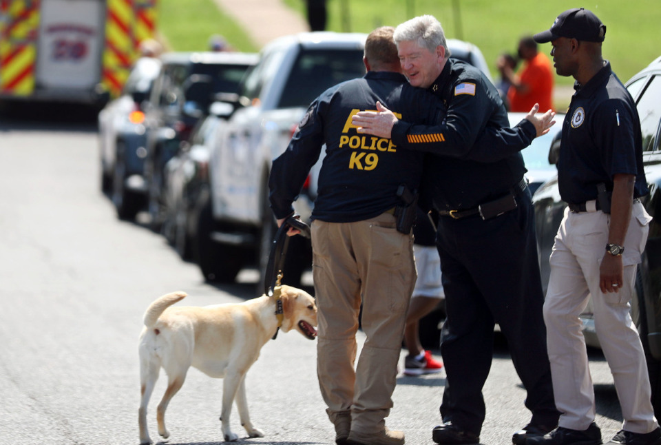 <strong>Memphis Police Department interim chief Mike Ryall hugs ATF special agent Mark Jordan, who's handling Piper, a 3-year-old explosives detection K-9, at the fourth Unity Walk Against Gun Violence at Hamilton High School June 12, 2021.</strong> (Patrick Lantrip/Daily Memphian)