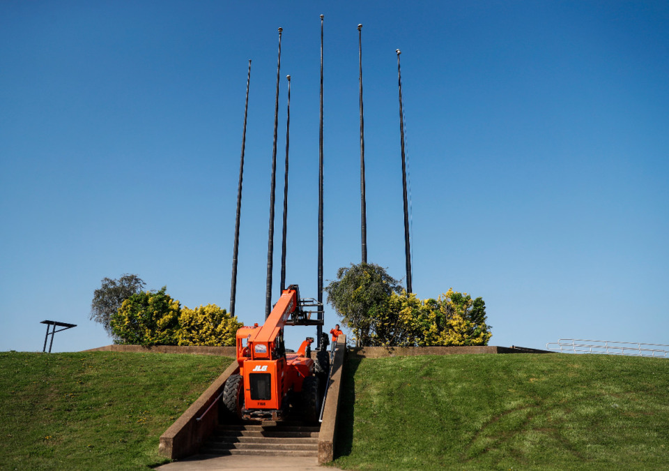 <strong>A work crew with 901Demo.com began removing the seven flag poles from the south end of Mud Island on Tuesday, April 6, 2021.</strong> (Mark Weber/The Daily Memphian)