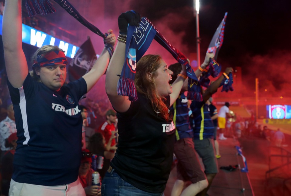 <strong>Molly Weldele (center) cheers for Memphis 901 FC after the home opener win against Atlanta United 2 on June 16.</strong> (Patrick Lantrip/Daily Memphian)