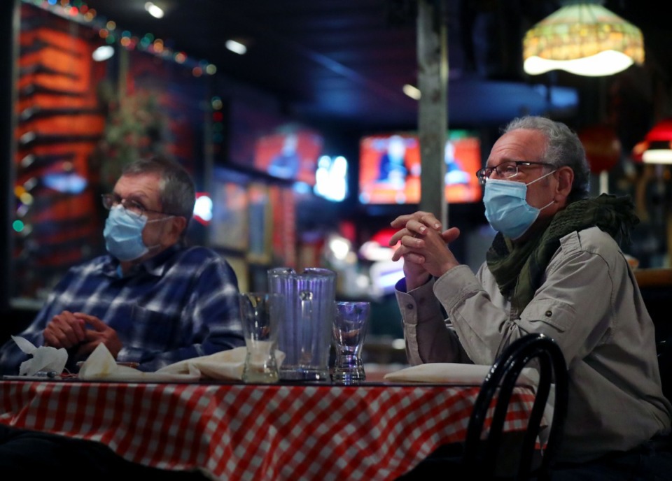 <strong>Michael Rowland (right) and Harry Freeman talk with friends during lunch at Rendezvous Dec. 1, 2020.</strong> (Patrick Lantrip/Daily Memphian file)